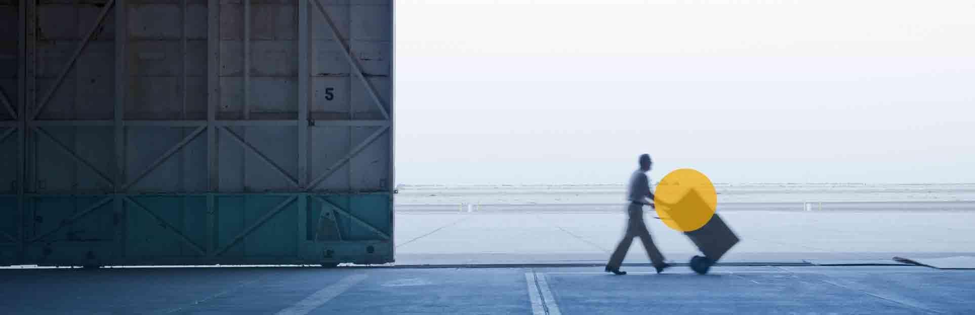 man pushing trolley by sea