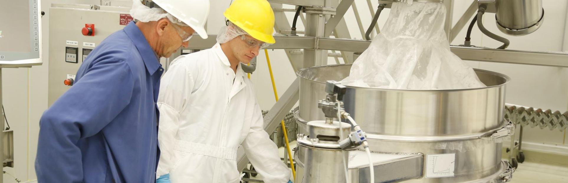 men in lab making custom premix