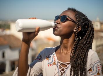 woman drinking out of water bottle