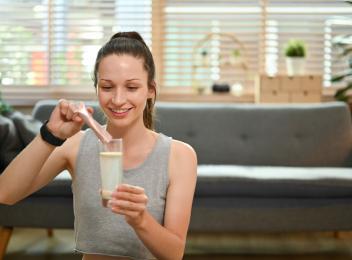 woman pouring powder mix into water