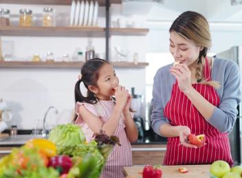 woman and child eating apple