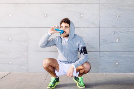 man sitting drinking shake after working out