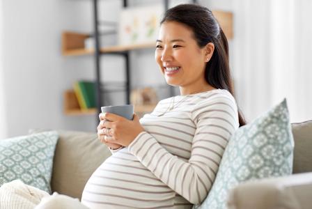 pregnant woman drinking beverage