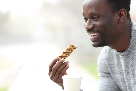 man eating granola bar