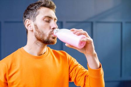 man drinking beverage