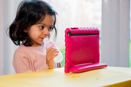 Girl eating yogurt beverage