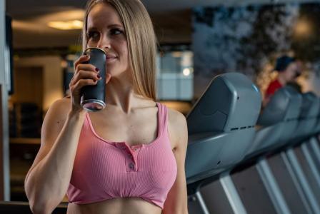 woman drinking beverage after workout