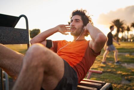man doing sit ups outside