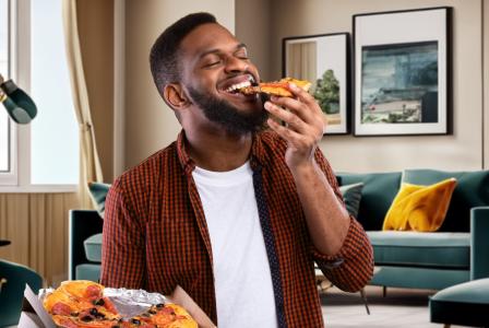 man eating pizza