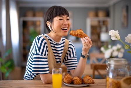 woman eating croissant