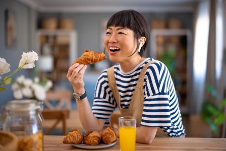 woman eating croissant