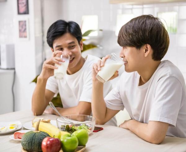 two men drinking milk