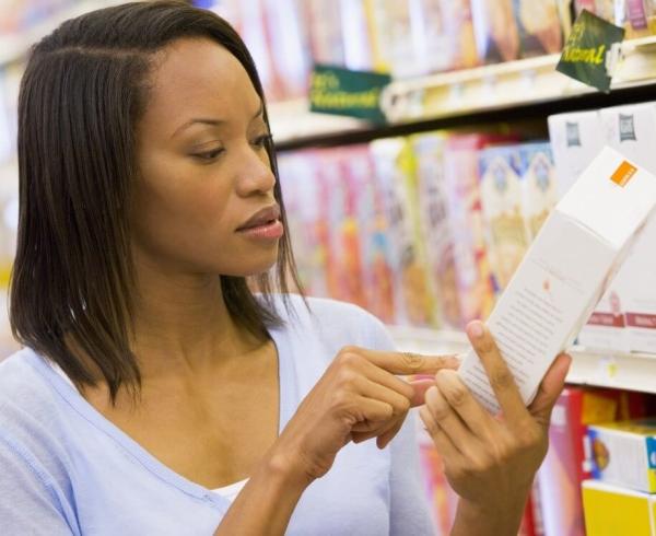 woman looking at cereal box