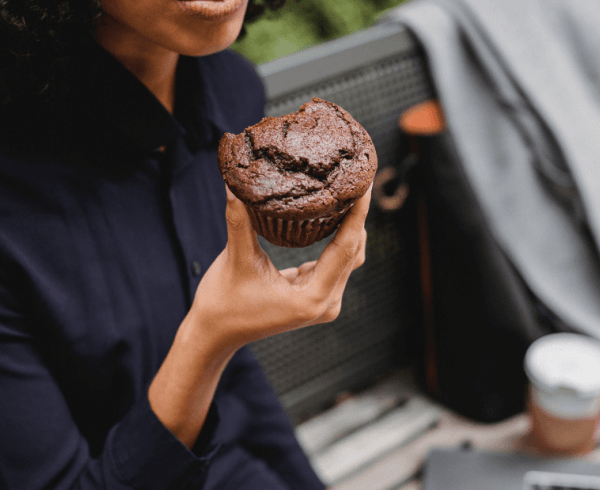 woman eating muffin