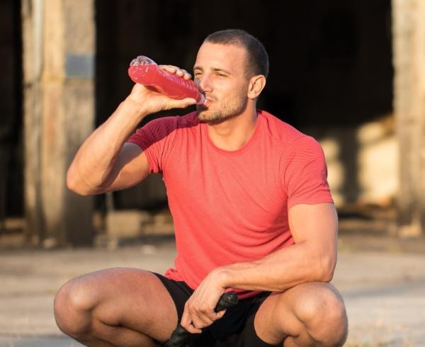 man drinking beverage