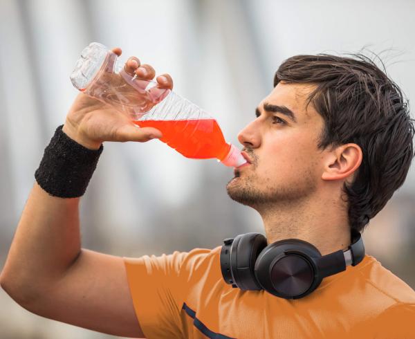 man drinking red beverage
