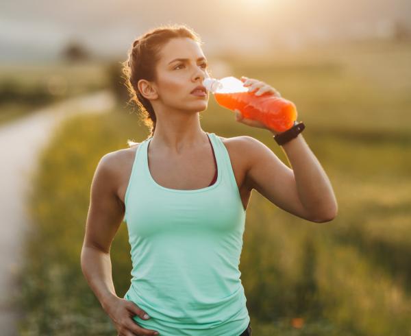 woman drinking beverage on walk