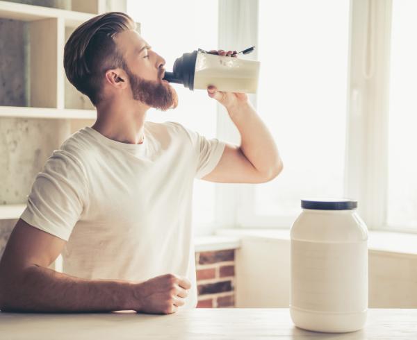 Man and Protein Powder Shaker