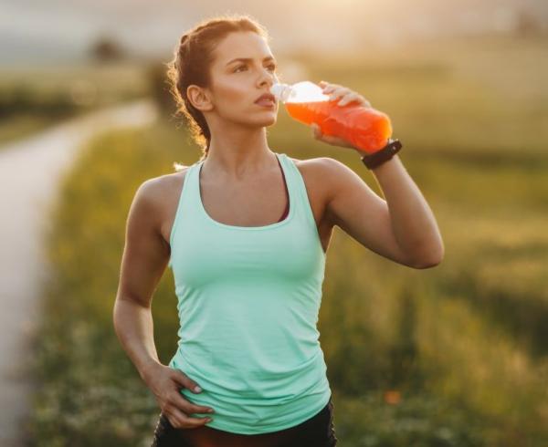 woman drinking hydration beverage