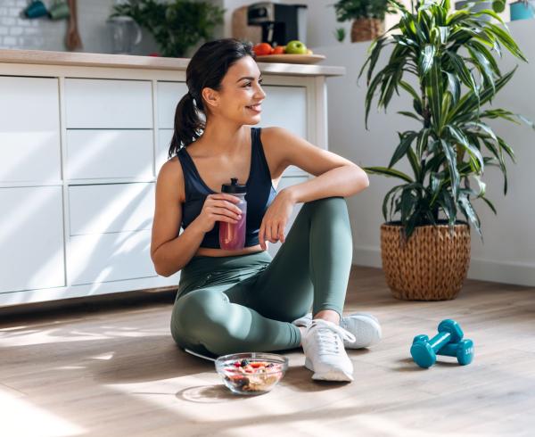 woman drinking beverage and eating bowl