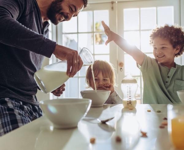 dad and kids pouring milk