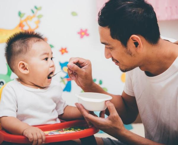 dad feeding baby