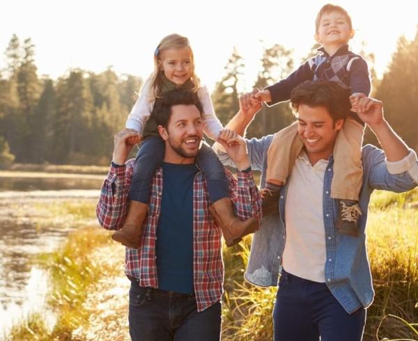 parents with kids on shoulder