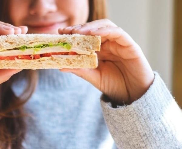 girl holding sandwich