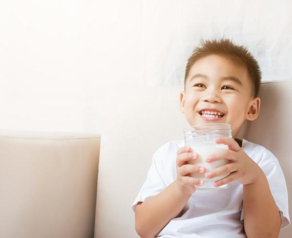 little boy with glass of milk