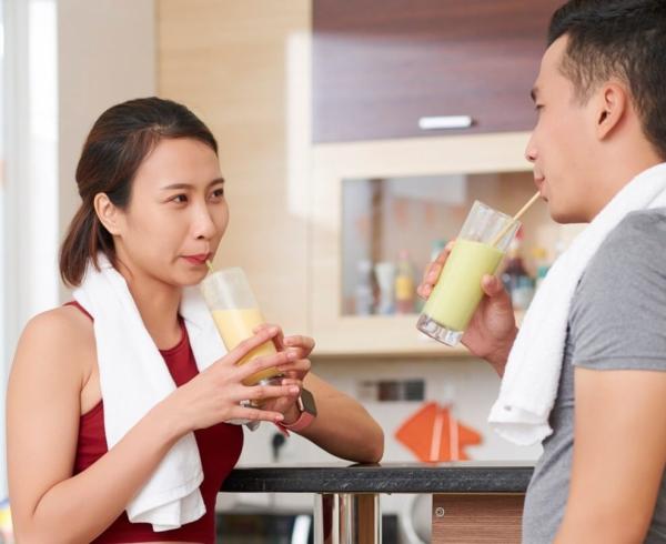 man and woman eating bar