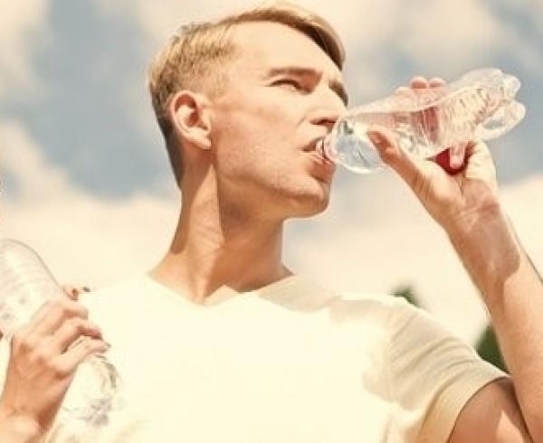 man and woman drinking water