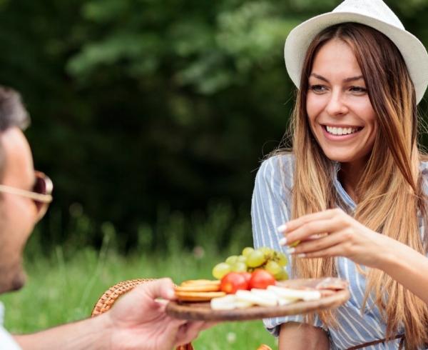 man and woman eating cheese 