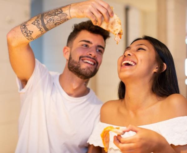 man feeding woman cheese