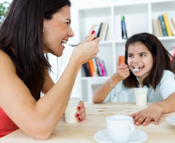 mom and daughter eating yogurt