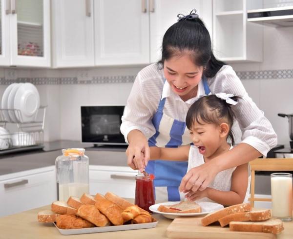 mom and daughter making toast