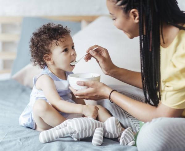 mom feeding toddler