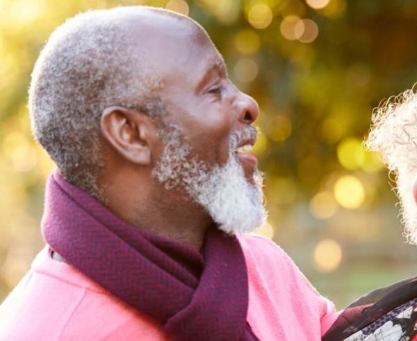 Senior couple laughing outside