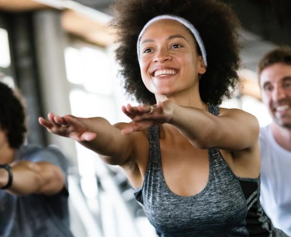 Three people participating in a workout class