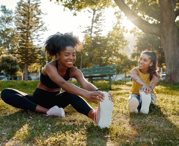 two girls stretching outside