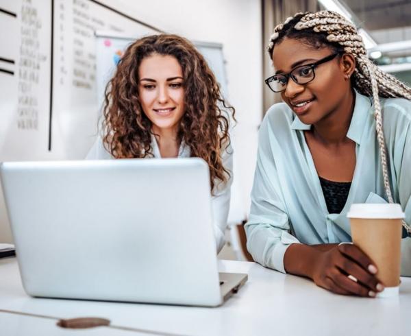 two women looking at computer