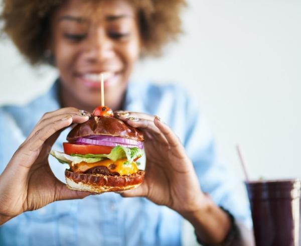 woman eating cheeseburger