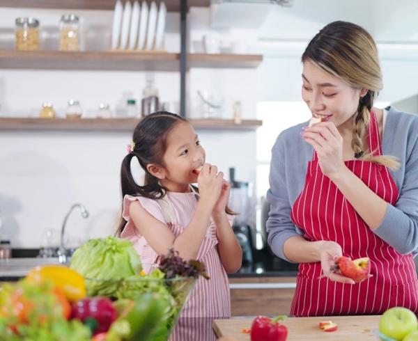 woman and child eating apple