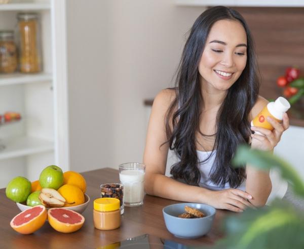 woman at table with supplements