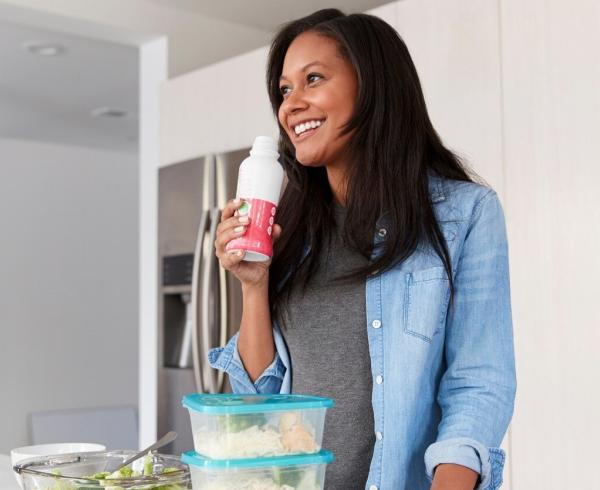 woman drinking beverage in kitchen