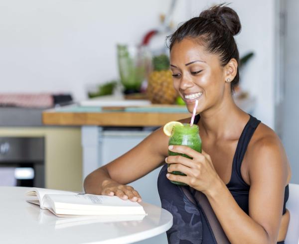 woman drinking green juice