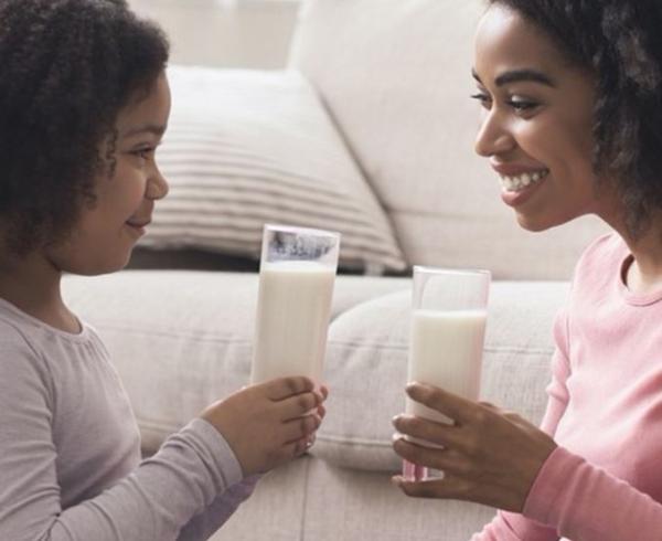 woman drinking milk with kid