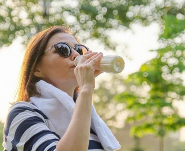 woman drinking shake after working out