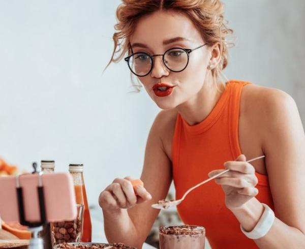 woman snacking and talking on phone