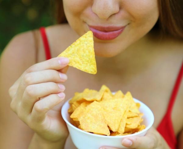 woman eating tortilla chips