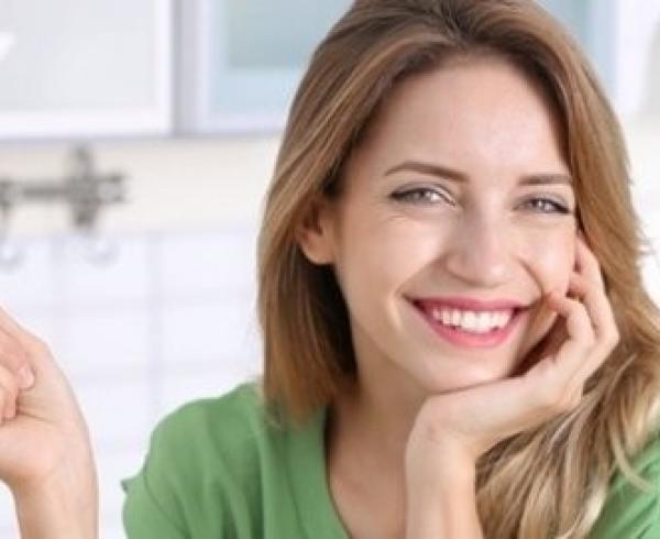 woman holding a fork with cucumber